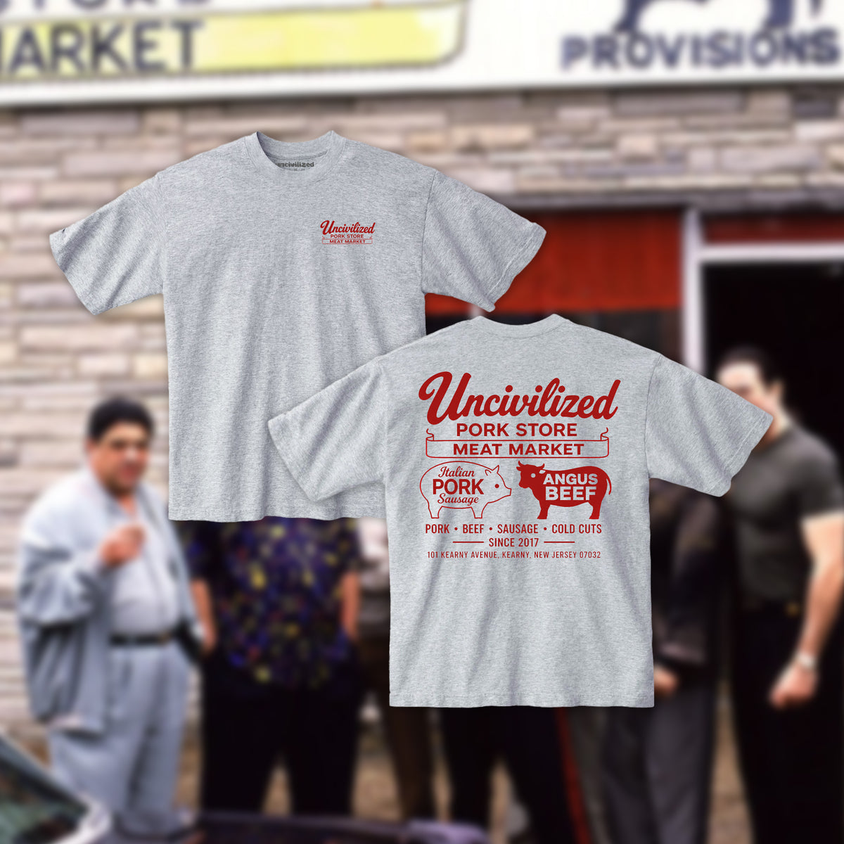 Two heather gray t-shirts shown against a blurred outdoor storefront background. The front view shows a small red 'Uncivilized' graphic on the left chest, and the back view shows a large red and white retro-style 'Uncivilized Pork Store Meat Market' graphic with a pig-shaped logo and 'Angus Beef' text.